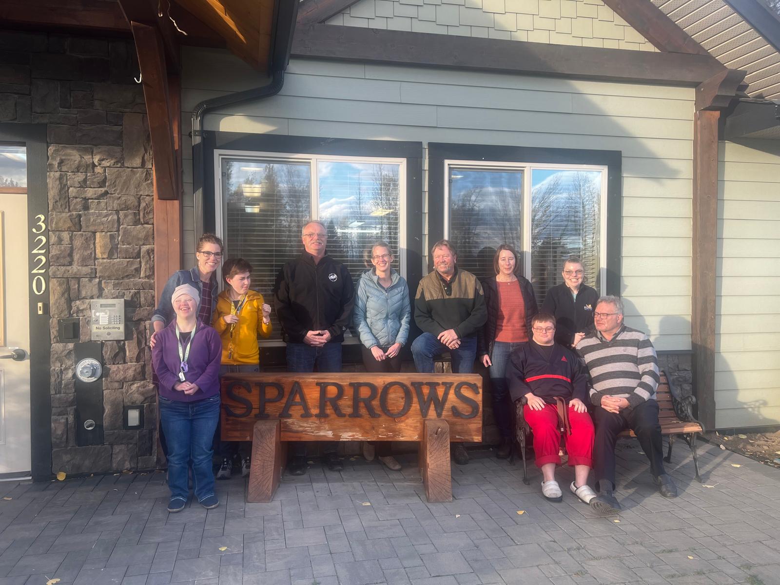 Residents and staff of Sparrows Christian Housing Society gathered together in their community home, showing the warm and inclusive family environment